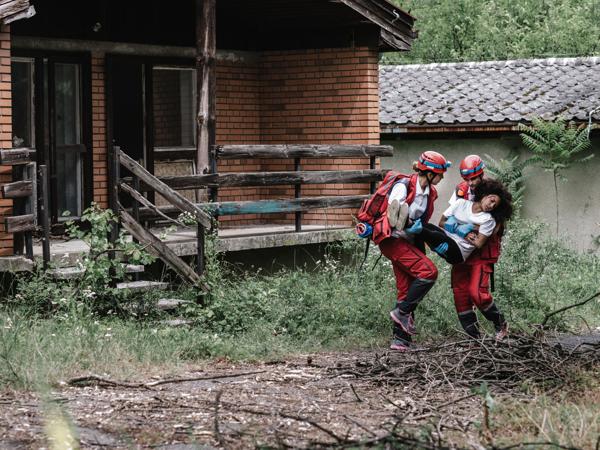 Rescue workers aiding disaster victim