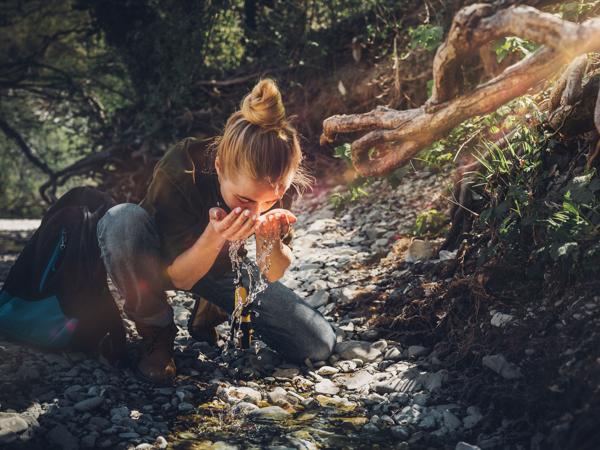 Woman washing face in river